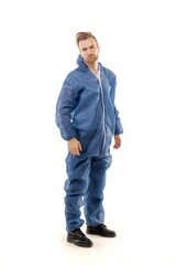 Naklejka premium A middle-aged white man wearing blue overalls for paintwork standing over isolated white background looks happy. Worker and builder concept.