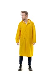 Fototapeta premium A middle-aged white man wearing a yellow raincoat standing over isolated white background looks happy. Worker concept.