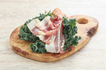 Raw pork bacon over board