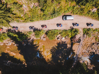 aerial view of quad bike riders at mountain trail road