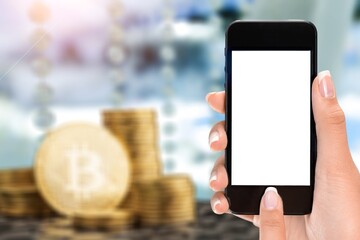 Hand holds smartphone with bitcoin cryptographic on background concept