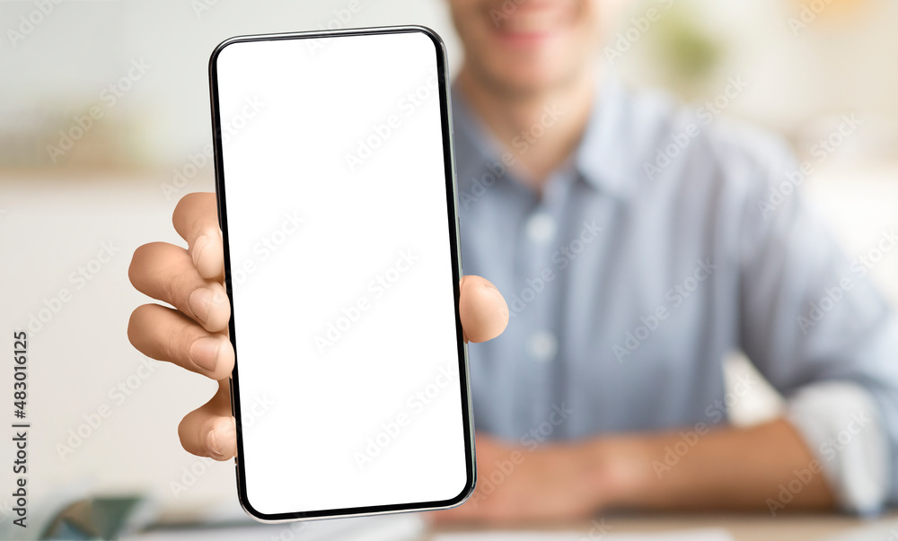 Poster Man showing white empty smartphone screen close to camera