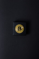 a bitcoin bitcoin on a dark background. minimalistic composition. Concept gift . Copy space