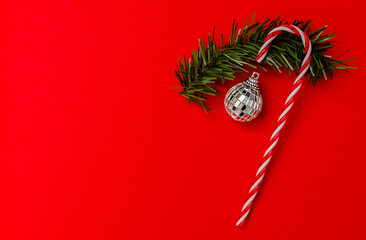 Caramel cane with Christmas and New Year decorations top view . space for text