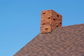 Fototapeta na wymiar Close up brick chimney on the roof