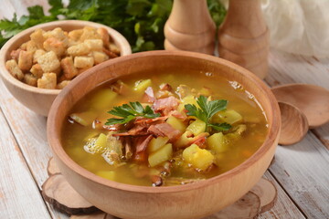 Lentil pea soup garnish with bacon, fried onion and croutons