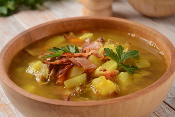 Lentil pea soup garnish with bacon, fried onion and croutons