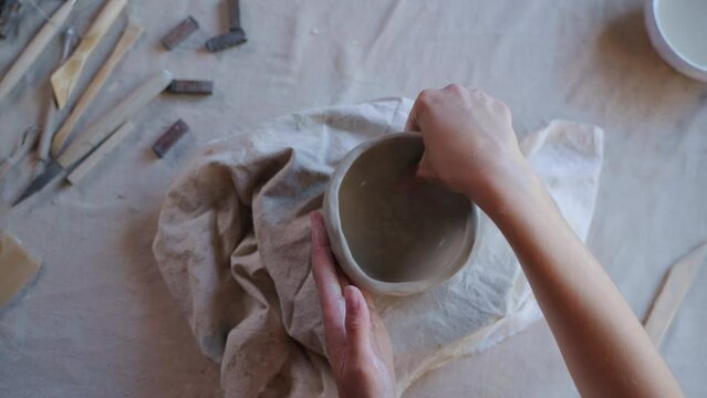 Female potter creating ceramic product
