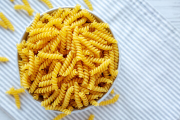 Raw Dry Organic Rotini Pasta Ready to Cook. Top view, from above, flat lay. Space for text.