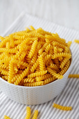 Raw Dry Organic Rotini Pasta Ready to Cook, low angle view. Close-up.