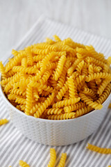 Raw Dry Organic Rotini Pasta Ready to Cook, side view. Close-up.