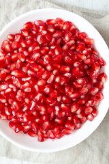 Red Pomegranate Seeds in a Bowl, top view. Flat lay, overhead, from above. Close-up.