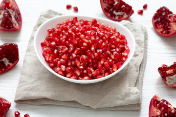 Red Pomegranate Seeds in a White Bowl , low angle view.