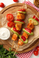 Concept of tasty food with chicken shashlik on white background