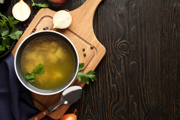 Concept of tasty food with chicken soup or broth on wooden background