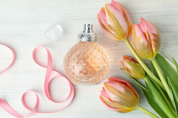 Concept of female perfume on white wooden table