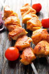 Concept of tasty food with chicken shashlik on dark wooden background
