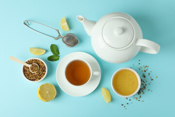 Obraz na płótnie Canvas Concept of hot drink with buckwheat tea on blue background