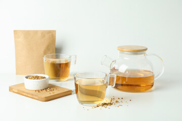 Concept of hot drink with buckwheat tea on white table