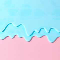 Pouring neo blue mint paint on pastel pink background. Creative abstract pattern with copy space.