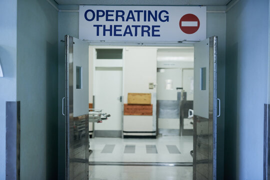 Open for surgery. Shot of open doors leading to an operating room in a hospital.