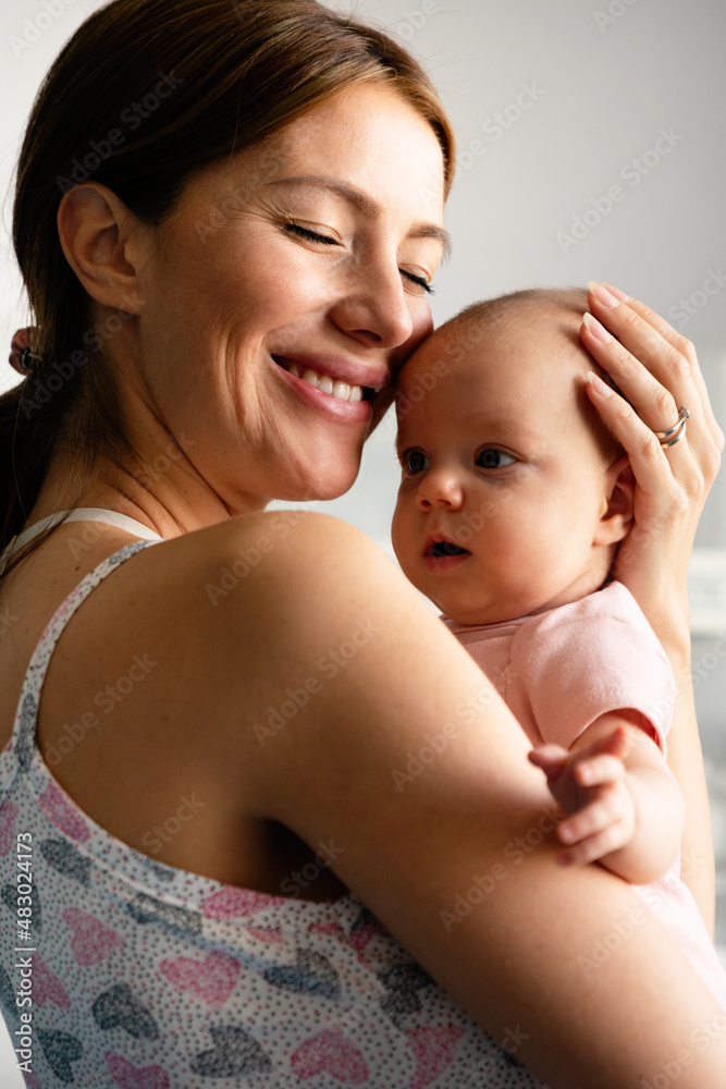 Wall mural Beautiful mother and her newborn baby together. Love, happiness, family concept.