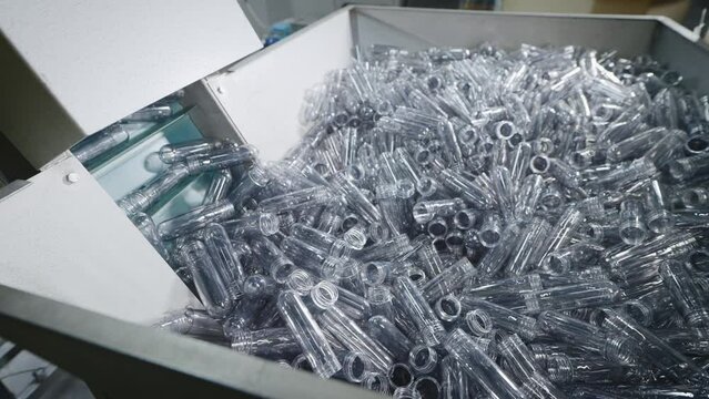 Automatic line for molding plastic, polyethylene bottles. Container with blanks.