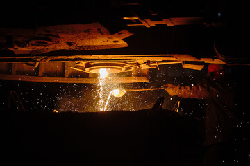 Metallurgist steelmaker takes a sample of liquid metal from a ladle. Ingot casting. Steel...