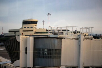 evocative image of the final part of the boarding sleeve or telescopic gangway (boarding pier) of an airport
seen from the windows on a bad day 
