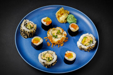 Japanese sushi on a porcelain plate on a black background