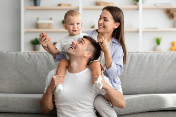 Happy Family Portrait. Cheerfu parents with infant son having fun at home