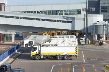 Trucks parked in a row specially equipped for aircraft de-icing before departure.