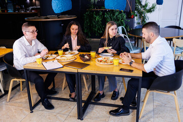Young designers discuss new project ideas with their partners in the conference room at lunch. Business people are discussing a new business project in the office.