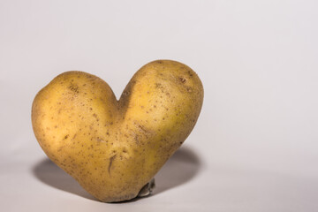 potatoe with form of a heart and gray background large
