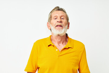 Obraz premium Photo of retired old man with a gray beard emotion gestures hands light background