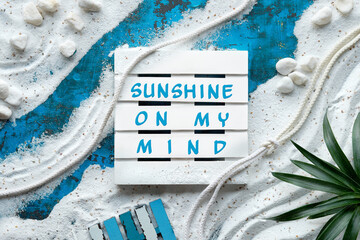 Sunshine on my mind text. Background with white sand on turquoise blue texture, shells, starfish....