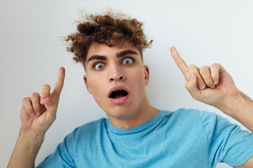 handsome man with curly hair in a blue t-shirt