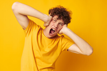 cute red-haired guy yellow t-shirt fashion hand gestures yellow background unaltered