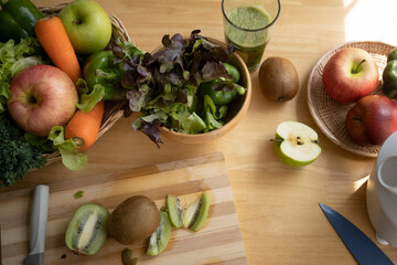 Above view of ingredients for healthy food with fresh vegetables and fruits on wooden table.