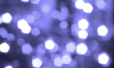 Festive abstract blurred background very peri color. Bokeh effect. Holiday decor concept