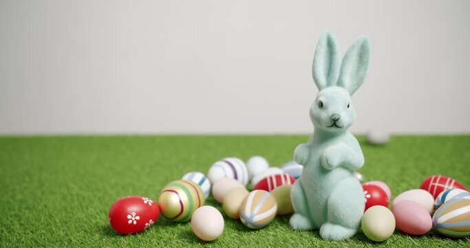 Rabbit Toy on a White background of green grass with many colored eggs, Text.