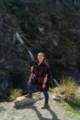 Chica joven guapa con gafas en entorno natural tomando fotografías mientras esta de senderismo en un parque natural