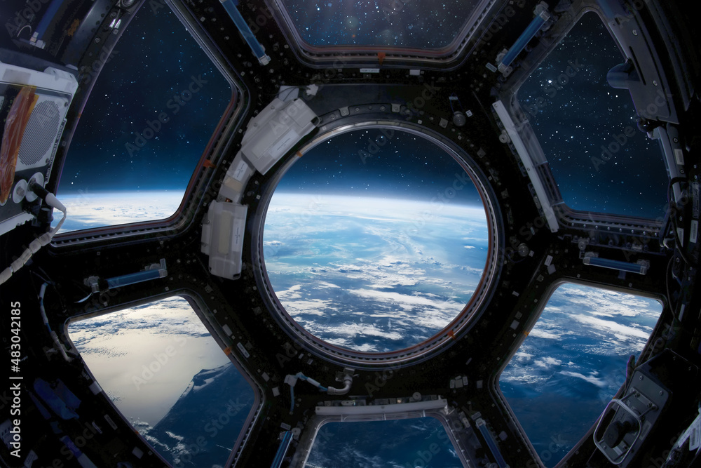 Poster earth planet in the iss porthole. view from cupole. international space station. surface and horizon