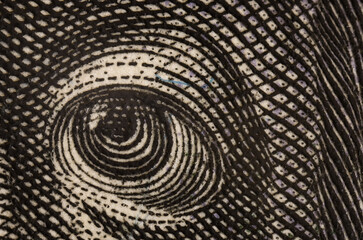 Benjamin Franklin's eye, detail from a portrait of a 100 dollar bill. United states money closeup. Ultra macro photography.