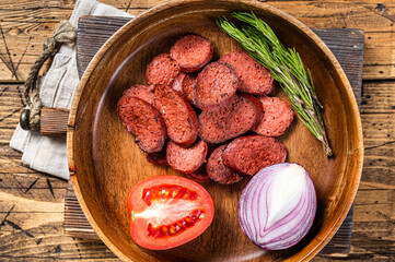 Turkish breakfast with Fried sausage sucuk on a rustic plate. Wooden background. Top view