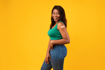 Vaccinated Black Young Woman Posing In Studio On Yellow Background