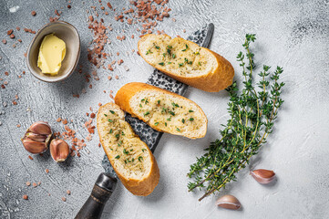 Garlic butter on Toasted Baguette bread with Salt, Pepper, Thyme and Olive. White background. Top...