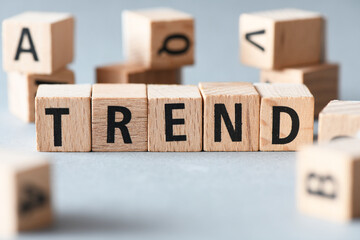 TREND word written on wooden cubes standing in a row.