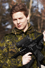 Proudly protecting his country. A young soldier standing with a rifle.