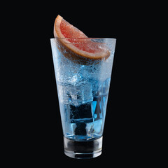 Blue lagoon cocktail with Blue Curacao liqueur in a tall glass isolated on black background. Classic alcoholic cocktail